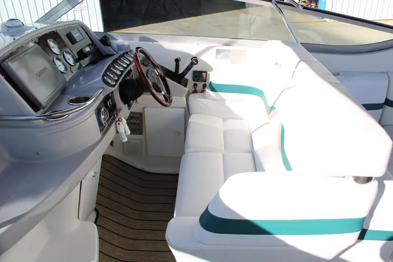 Slide: The Image of 1999 Formula 400 Super Sport boat cockpit with white seating and wooden steering wheel. - 27