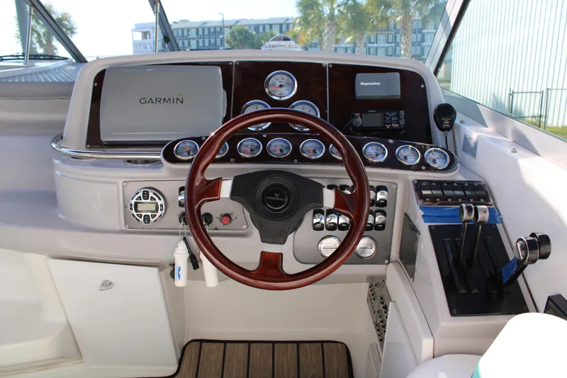 Slide: The Image of 1999 Formula 400 Super Sport boat dashboard with Garmin navigation system. - 28