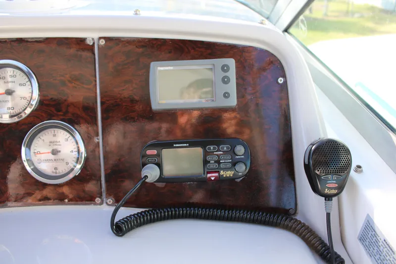 Slide: The Image of Dashboard of a 1999 Formula 400 Super Sport boat with gauges and communication equipment. - 30