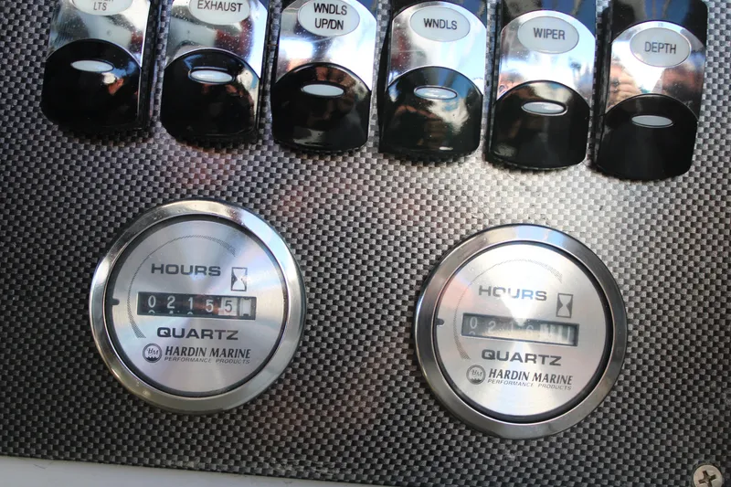 Slide: The Image of 1999 Formula 400 Super Sport boat dashboard with Hardin Marine hour meters and switches. - 31