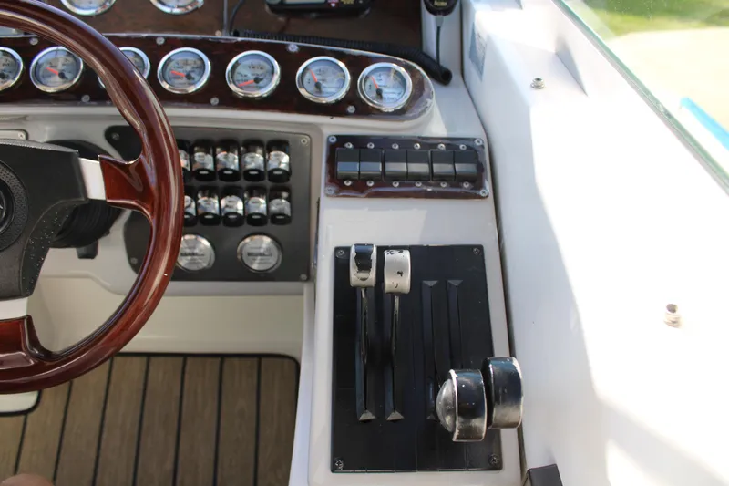 Slide: The Image of 1999 Formula 400 Super Sport boat dashboard with controls and gauges. - 32