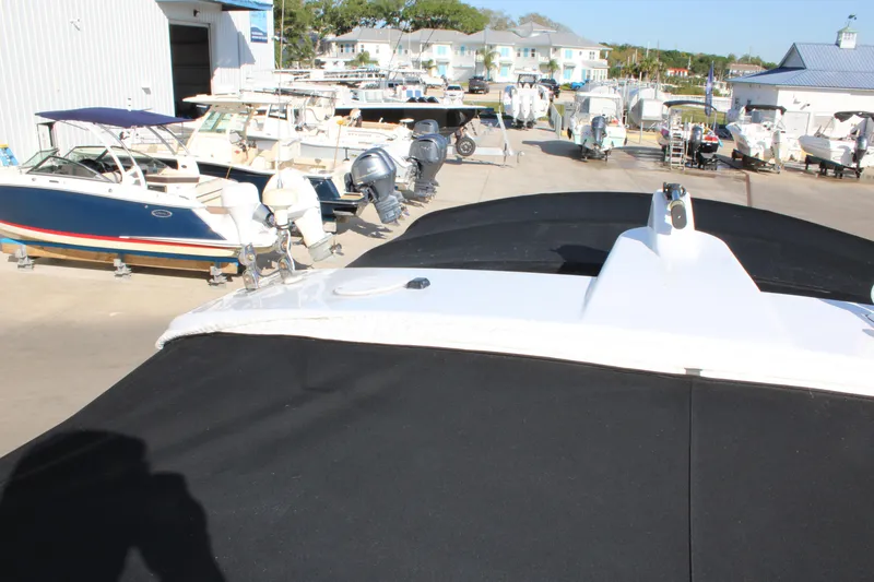 Slide: The Image of 1999 Formula 400 Super Sport boat in a marina with other boats. - 34