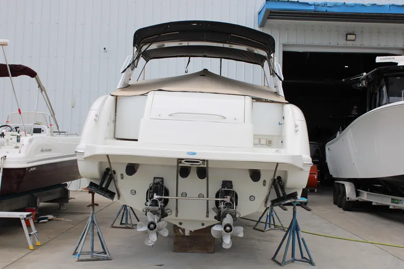 Slide: The Image of 1999 Formula 400 Super Sport boat on stands in a marina. - 4