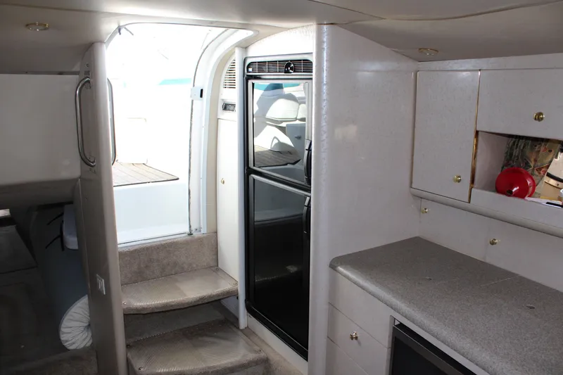 Slide: The Image of Interior of a 1999 Formula 400 Super Sport boat with stairs, cabinets, and a refrigerator. - 41