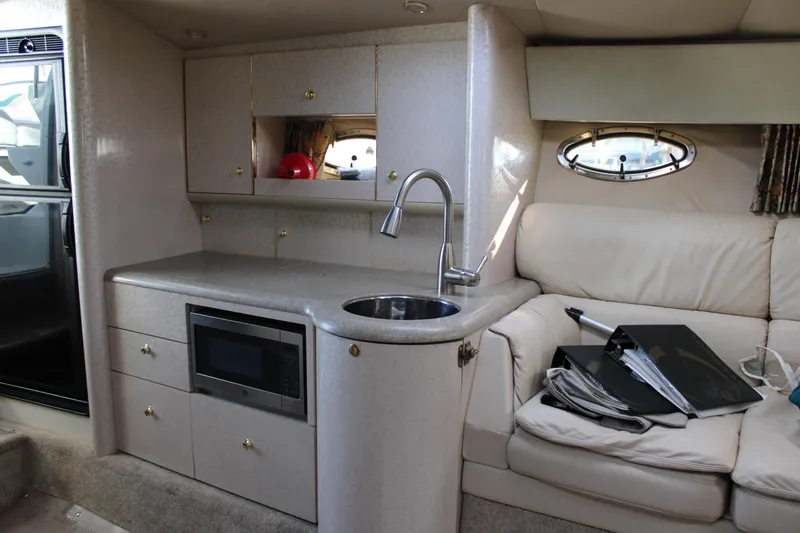 Slide: The Image of Interior of a 1999 Formula 400 Super Sport yacht with kitchenette and seating area. - 42