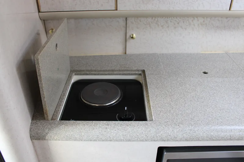 Slide: The Image of 1999 Formula 400 Super Sport boat interior kitchen stove. - 46