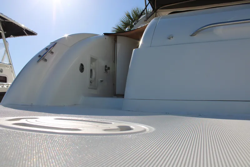 Slide: The Image of 1999 Formula 400 Super Sport boat deck and stern view under clear sky. - 9