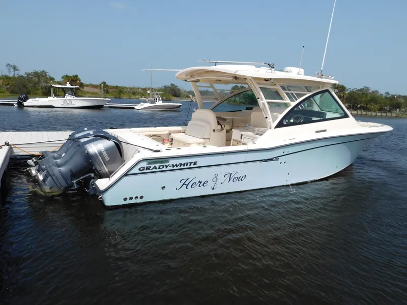Slide: The Image of 2018 Grady-White Freedom 375 boat docked on calm water. - 1