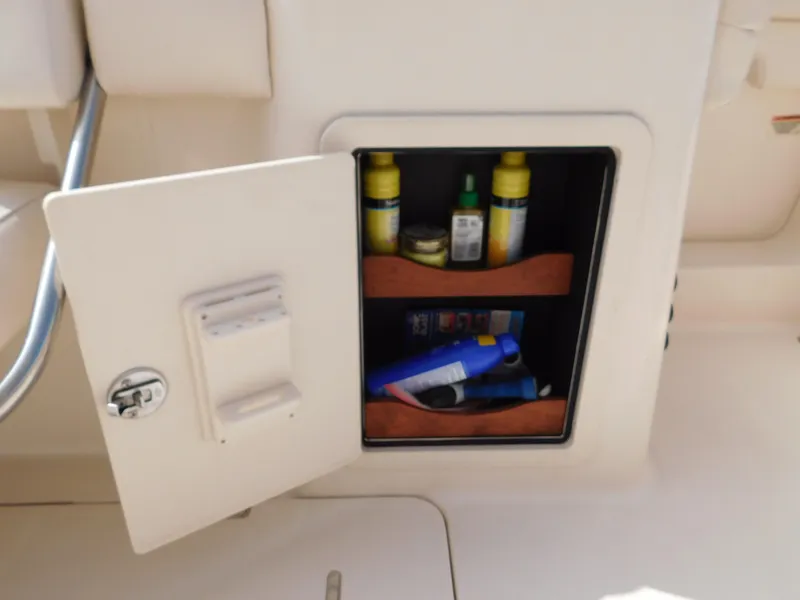 Slide: The Image of Open storage compartment on 2018 Grady-White Freedom 375 boat with various items inside. - 11