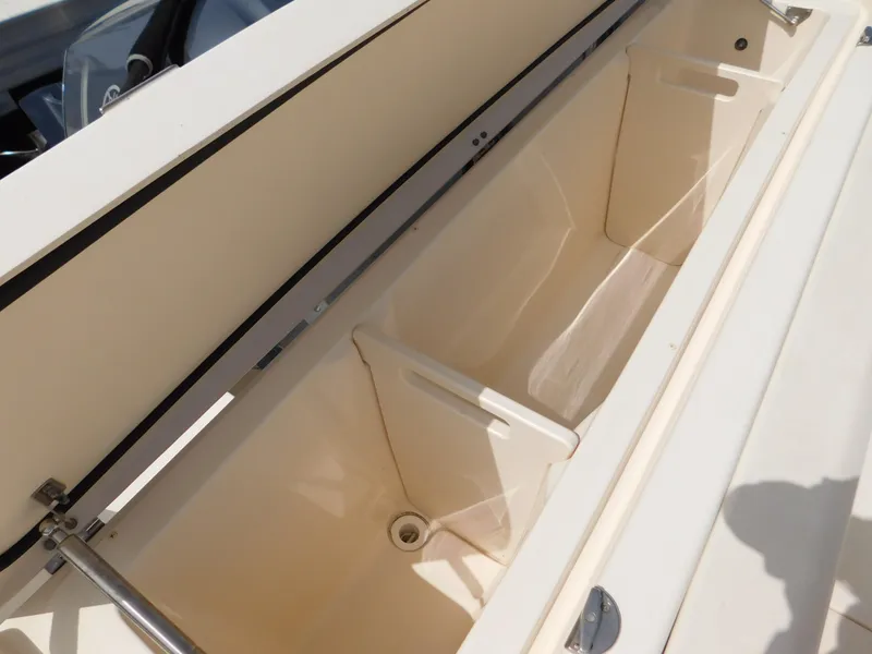 Slide: The Image of 2018 Grady-White Freedom 375 storage compartment, open and empty, showcasing interior space. - 13