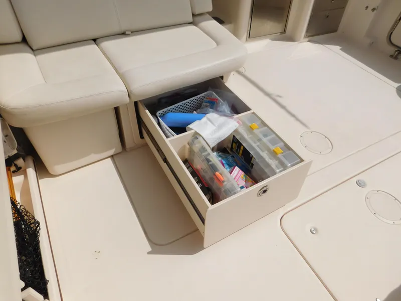 Slide: The Image of 2018 Grady-White Freedom 375 boat interior with open storage drawer containing various items. - 15