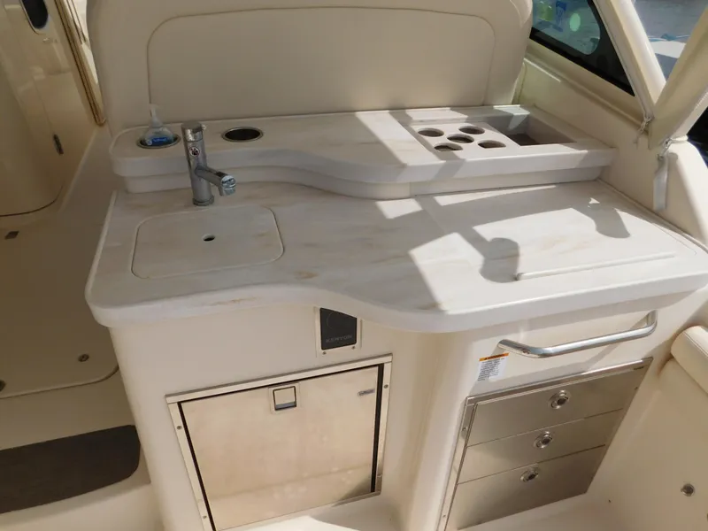 Slide: The Image of 2018 Grady-White Freedom 375 boat interior with sink and storage compartments. - 19