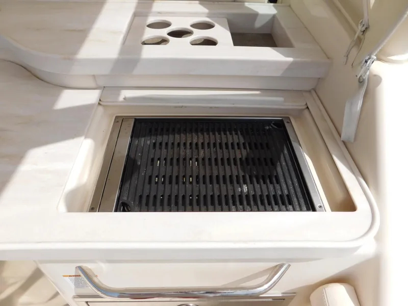 Slide: The Image of Built-in grill on 2018 Grady-White Freedom 375 boat, featuring cup holders and sleek design. - 20