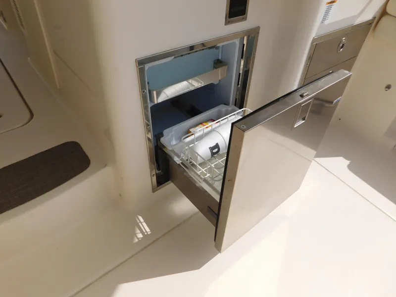 Slide: The Image of Built-in refrigerator on 2018 Grady-White Freedom 375 boat, open with visible contents. - 22