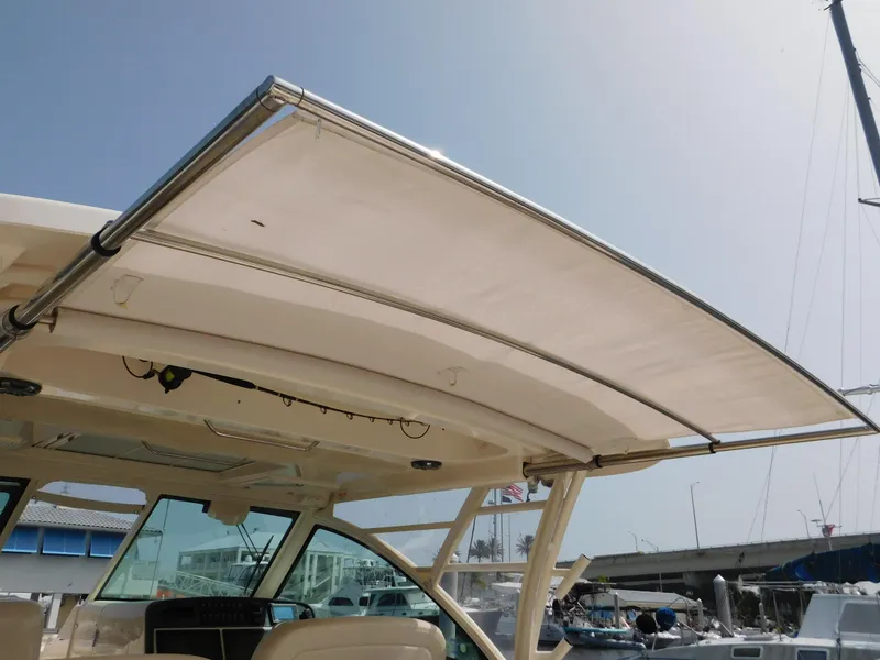 Slide: The Image of 2018 Grady-White Freedom 375 boat with retractable sunshade, docked at marina. - 25