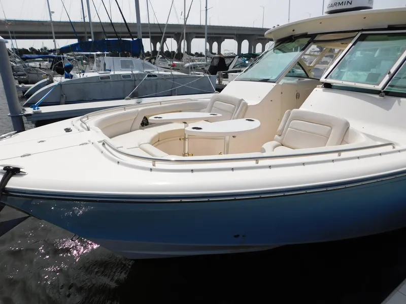 Slide: The Image of 2018 Grady-White Freedom 375 boat docked in marina, featuring spacious seating area. - 3