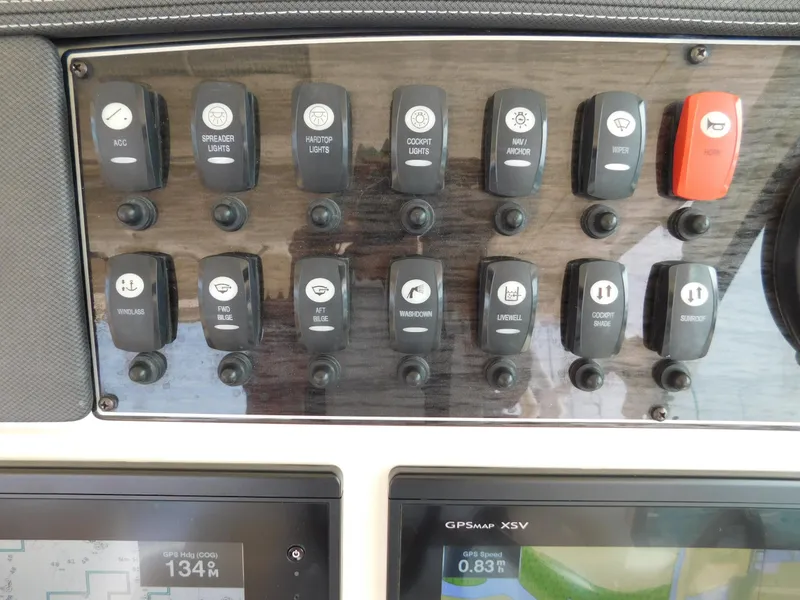 Slide: The Image of Control panel of 2018 Grady-White Freedom 375 boat with labeled switches and GPS display. - 31
