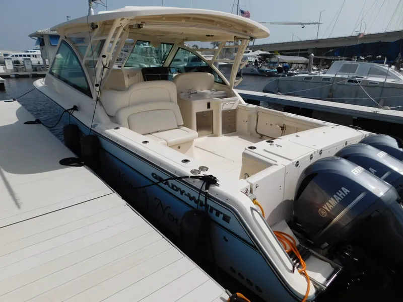 Slide: The Image of 2018 Grady-White Freedom 375 boat docked, featuring spacious seating and twin Yamaha engines. - 4