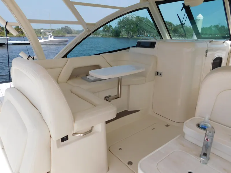 Slide: The Image of 2018 Grady-White Freedom 375 boat interior with seating and table, docked by the water. - 42