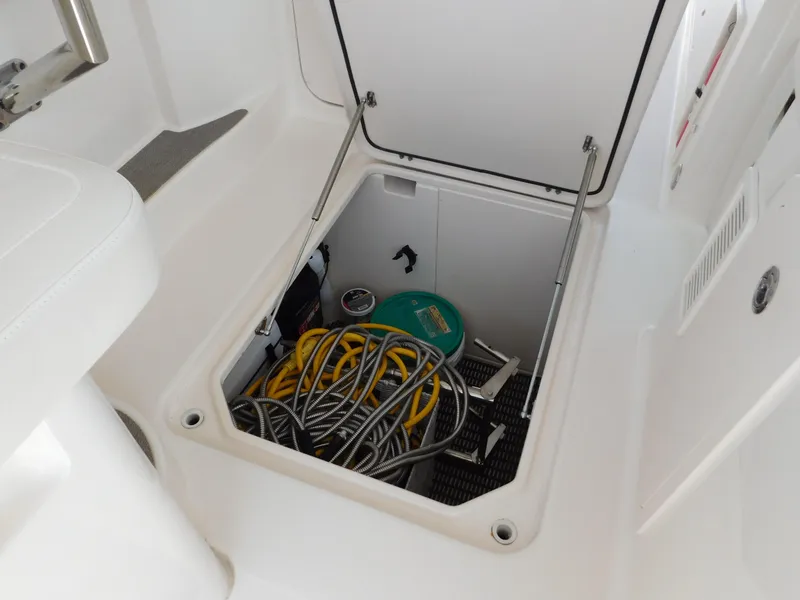 Slide: The Image of Storage compartment on 2018 Grady-White Freedom 375 boat with hoses and equipment. - 46