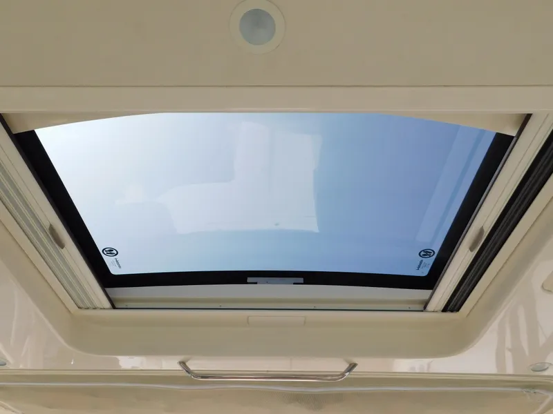 Slide: The Image of 2018 Grady-White Freedom 375 boat sunroof, showcasing sleek design and clear blue sky view. - 47