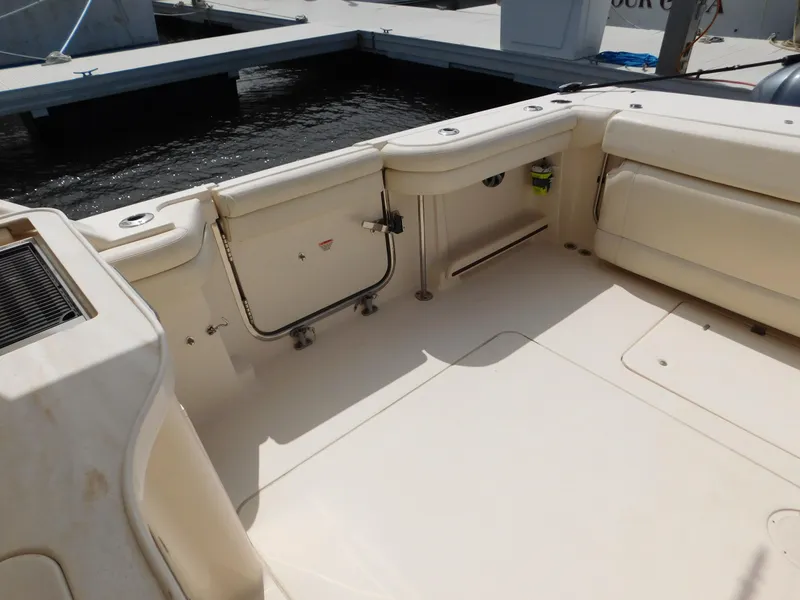 Slide: The Image of 2018 Grady-White Freedom 375 boat interior, featuring spacious seating and storage at the dock. - 6