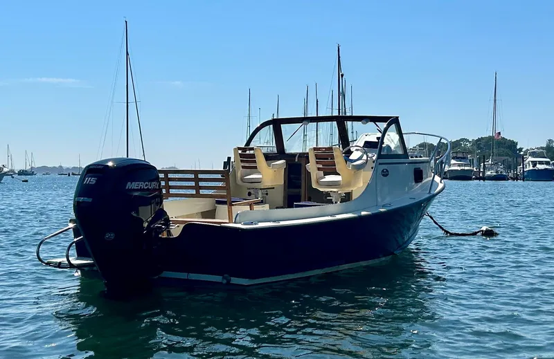 Slide: The Image of 2021 Seaway 21 Seafarer Cuddy boat on water with Mercury outboard motor. - 1