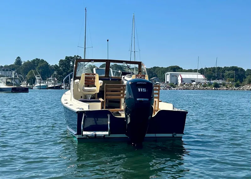 Slide: The Image of 2021 Seaway 21 Seafarer Cuddy boat on water with Honda 115 outboard motor. - 2