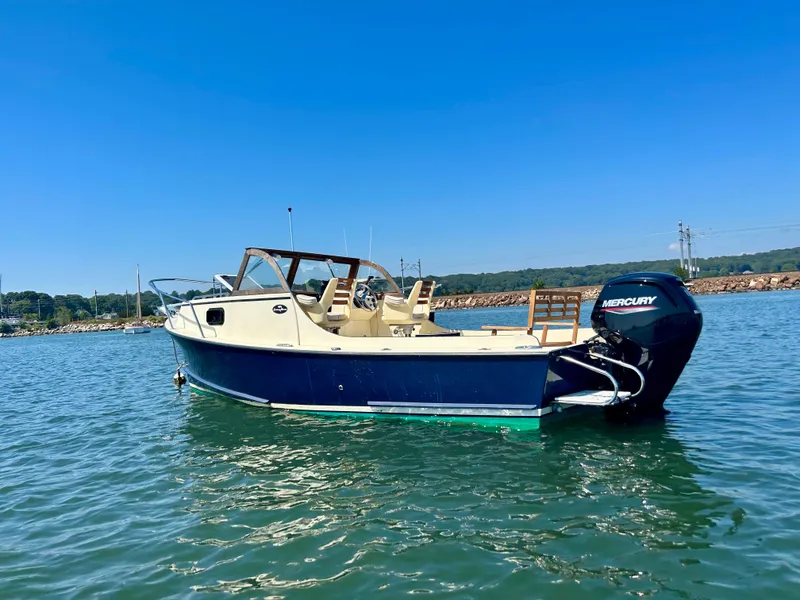 Slide: The Image of 2021 Seaway 21 Seafarer Cuddy boat on water with Mercury outboard motor. - 3