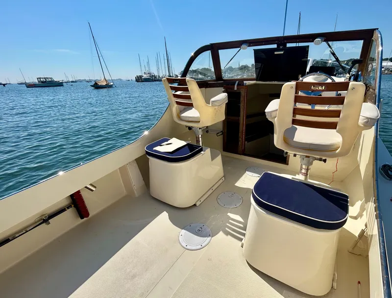 Slide: The Image of 2021 Seaway 21 Seafarer Cuddy boat interior with seating, on a sunny day at the marina. - 6