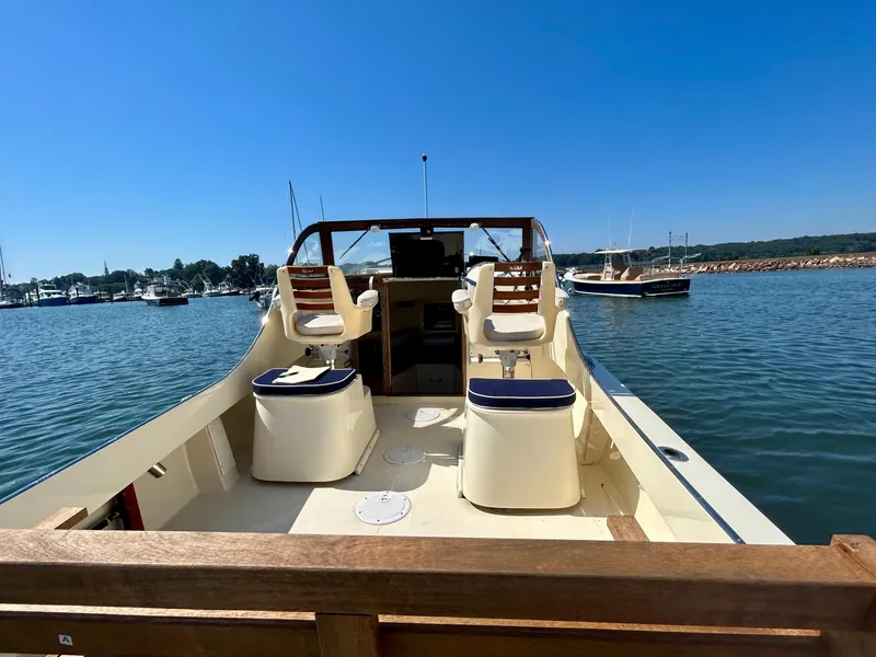 Slide: The Image of 2021 Seaway 21 Seafarer Cuddy boat on calm water, featuring spacious deck and seating. - 7