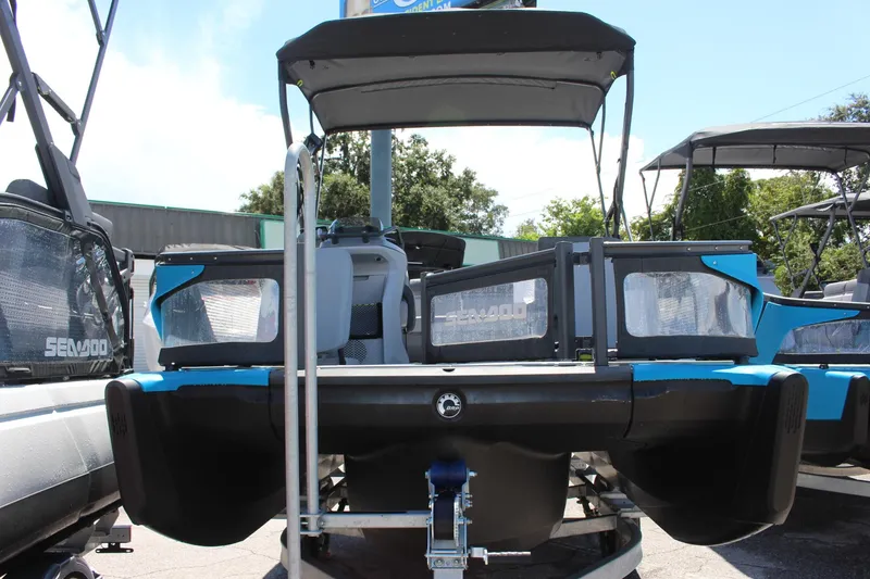Slide: The Image of 2023 Sea-Doo Switch Sport 18 - 230 HP pontoon boat, front view, on trailer. - 1