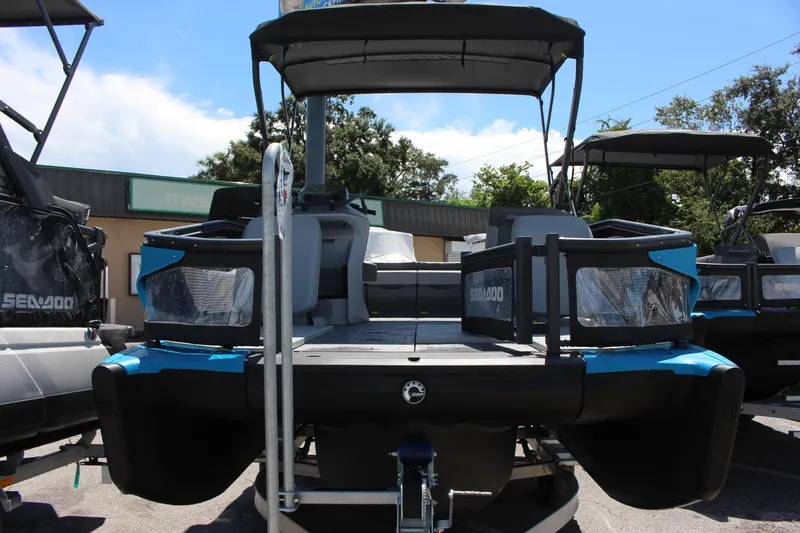 Slide: The Image of 2023 Sea-Doo Switch Sport 18 - 230 HP pontoon boat, front view in a dealership lot. - 11