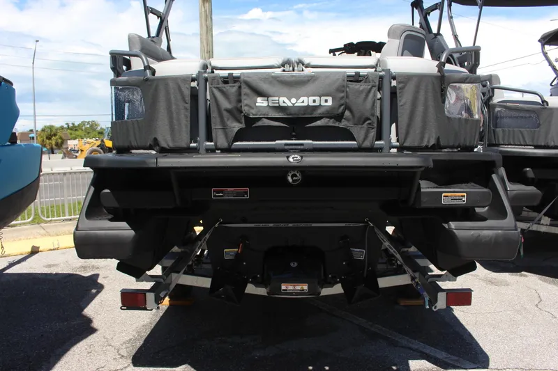 Slide: The Image of 2023 Sea-Doo Switch Sport 18 - 230 HP rear view at a dealership. - 13