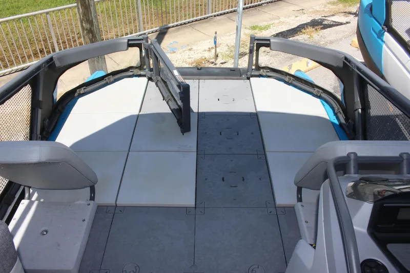 Slide: The Image of 2023 Sea-Doo Switch Sport 18 - 230 HP deck view with seating and storage. - 18