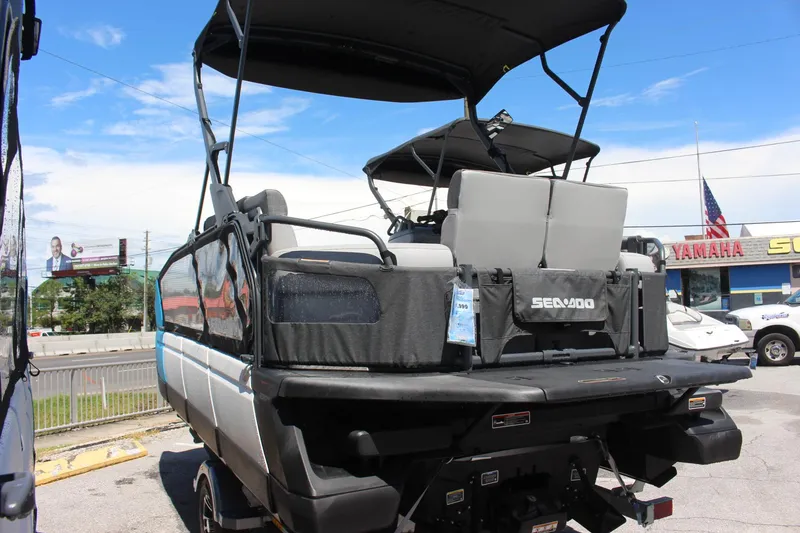 Slide: The Image of 2023 Sea-Doo Switch Sport 18 - 230 HP pontoon boat rear view in a dealership lot. - 2
