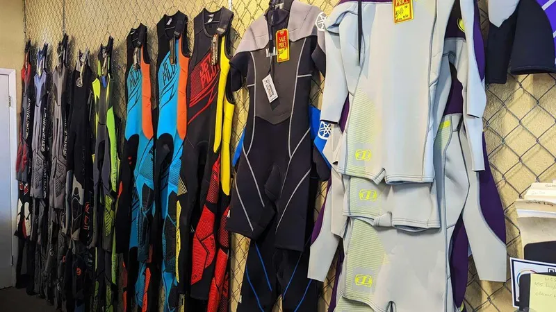 Slide: The Image of Colorful wetsuits on display in a store, perfect for water sports enthusiasts. - 9