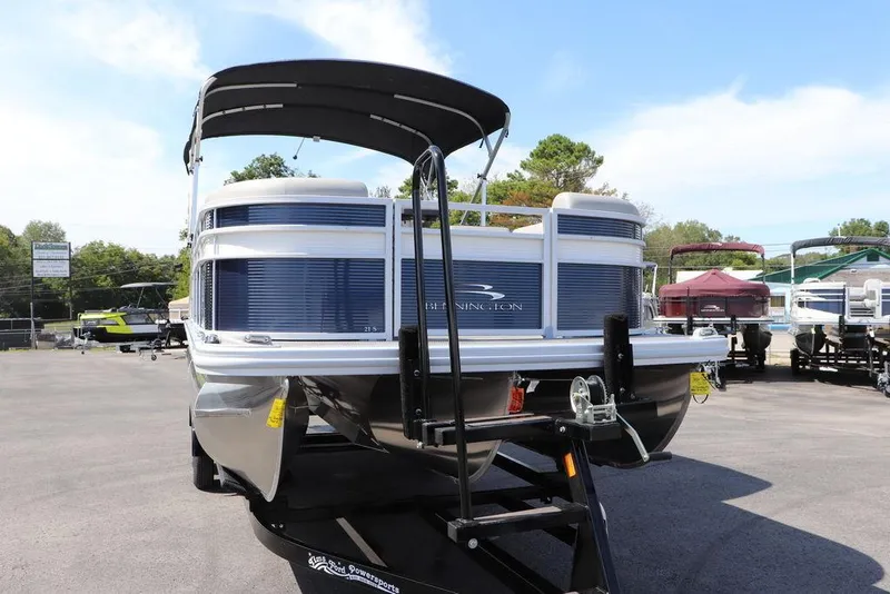 Slide: The Image of 2024 Bennington 21 SSR pontoon boat on a trailer in a dealership lot. - 15