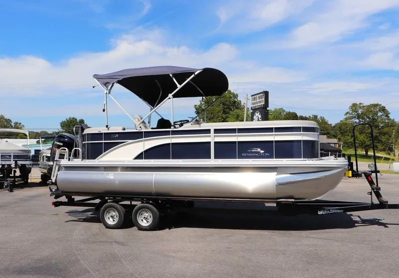 Slide: The Image of 2024 Bennington 21 SSR pontoon boat with canopy on trailer. - 4