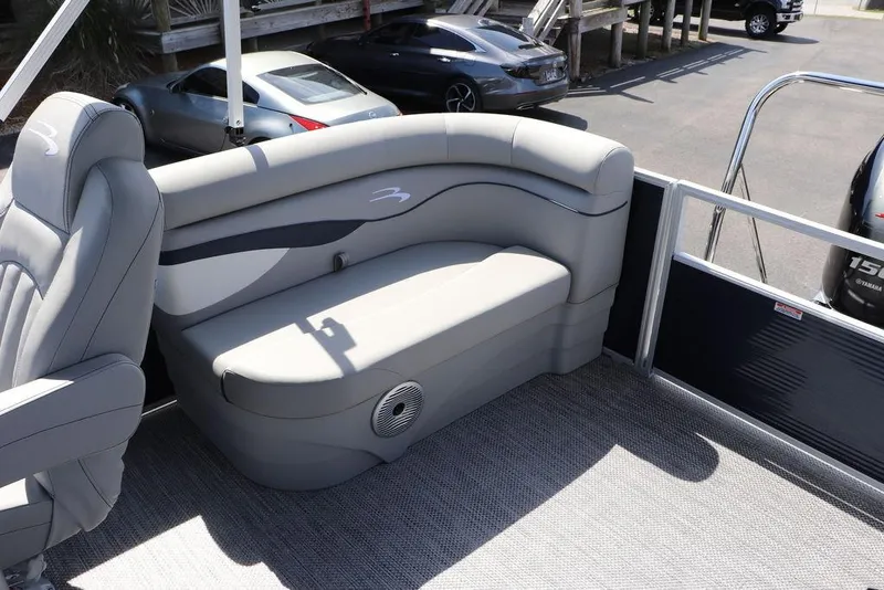 Slide: The Image of 2024 Bennington 21 SSR boat interior with gray seating and carpeted floor. - 9