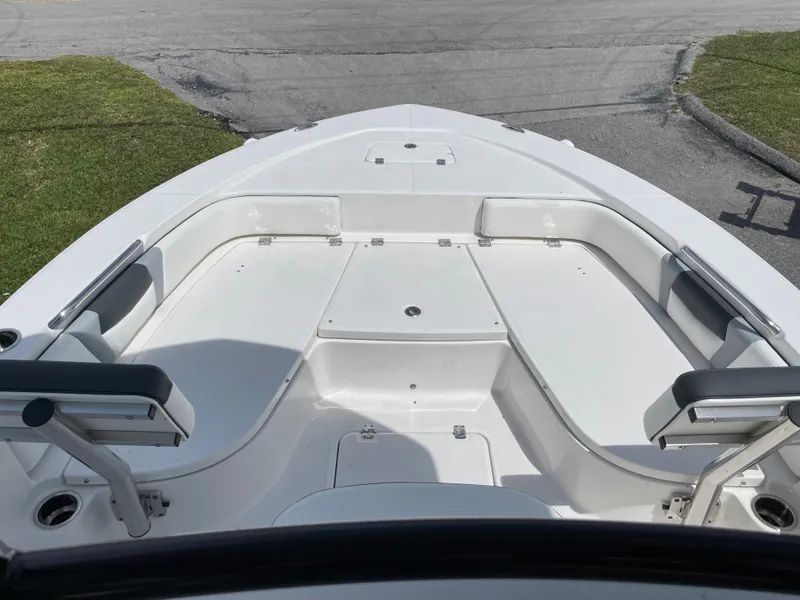 Slide: The Image of 2024 Robalo 226 Cayman boat bow seating area with white cushions. - 12