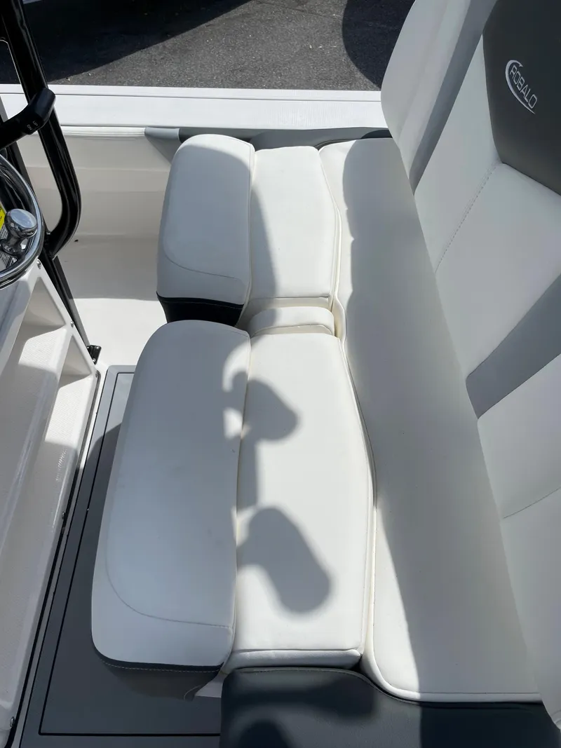 Slide: The Image of 2024 Robalo 226 Cayman boat seating area with white and gray upholstery. - 17