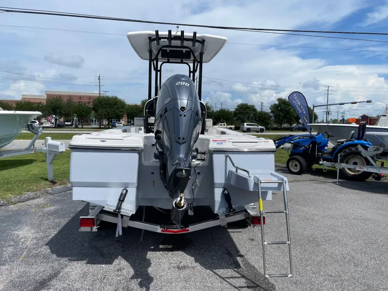 Slide: The Image of 2024 Robalo 226 Cayman boat with outboard motor and ladder, displayed outdoors. - 3