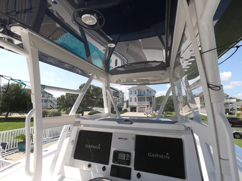 Slide: The Image of 2019 Invincible 39 CC boat helm with Garmin displays, outdoor setting. - 11