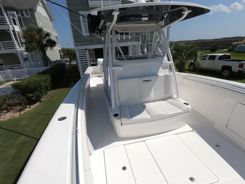 Slide: The Image of 2019 Invincible 39 CC boat with sleek white seating and modern design. - 12