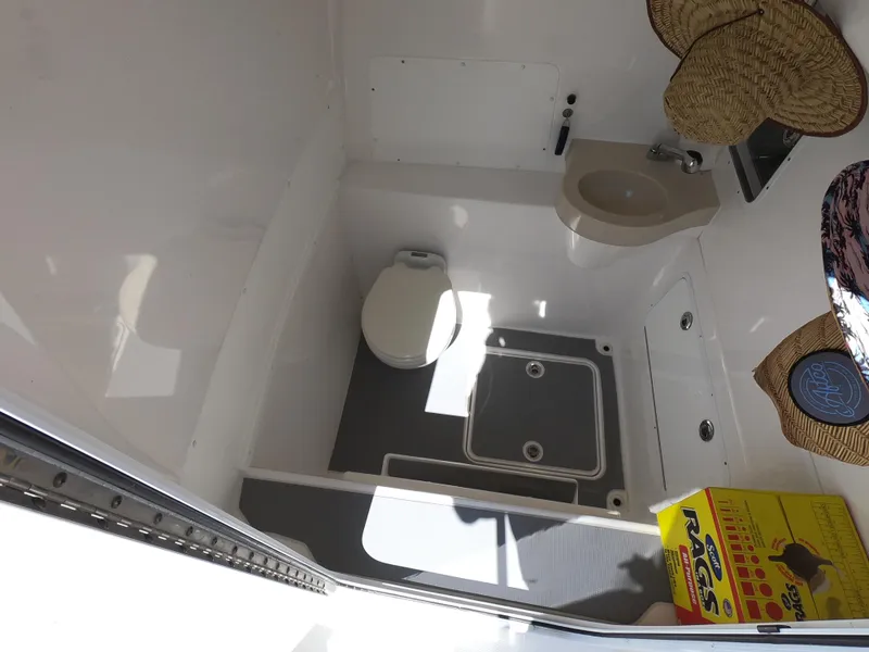 Slide: The Image of Compact bathroom in 2019 Invincible 39 CC boat, featuring toilet and sink. - 19