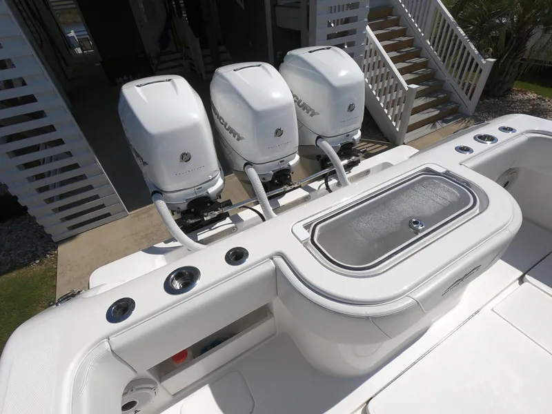 Slide: The Image of 2019 Invincible 39 CC boat with triple outboard engines and sleek white deck design. - 21