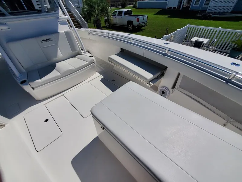 Slide: The Image of 2019 Invincible 39 CC boat interior with white seating and deck. - 25