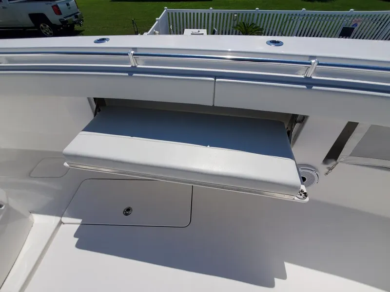 Slide: The Image of 2019 Invincible 39 CC boat with a fold-out seat on the deck. - 26