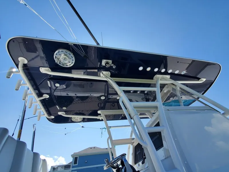 Slide: The Image of 2019 Invincible 39 CC boat, view of T-top and ladder under clear blue sky. - 27